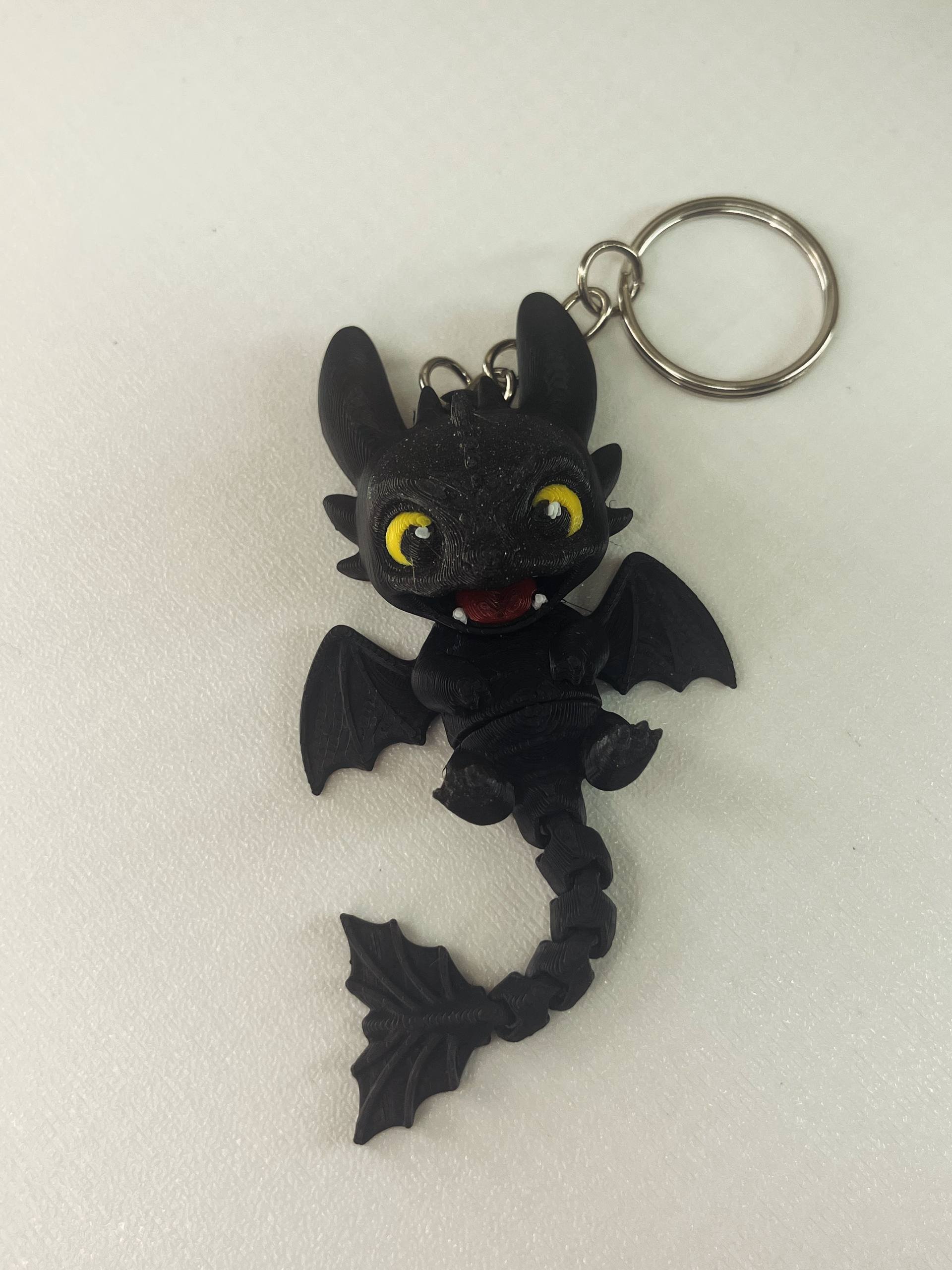 Keychain in the shape of a cartoon character from the movie How to Train Your Dragon. The keychain is made of plastic and