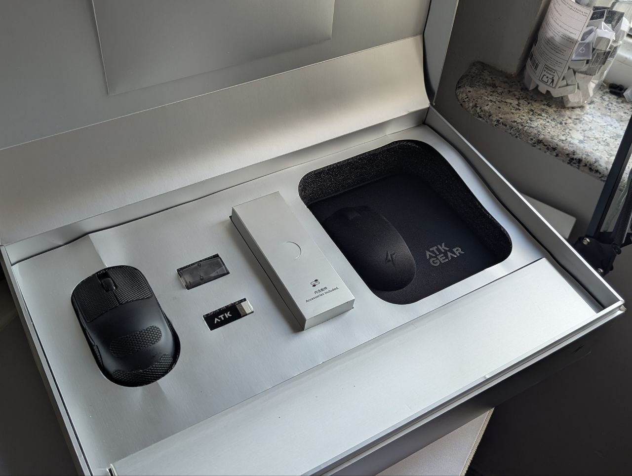 White box with the words "Mouse Fitting Kit" written on it in black. The box is open and appears to be a product packaging