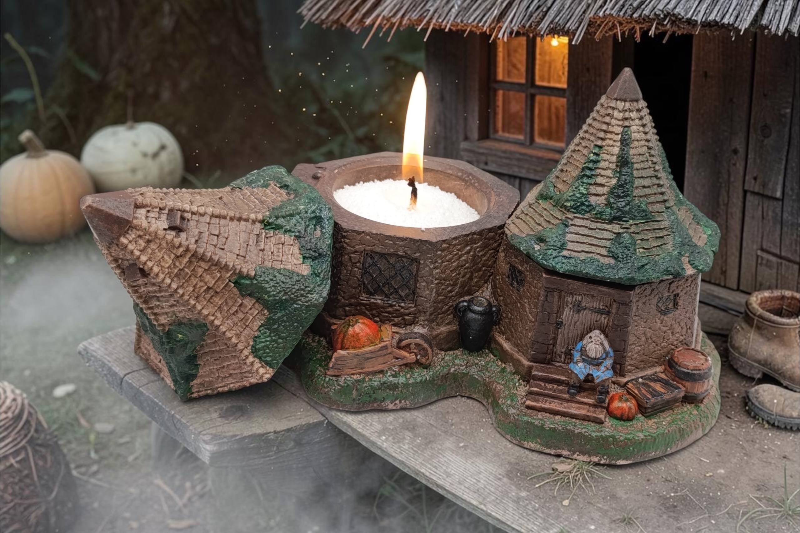Small figurine of a cottage with a thatched roof and a chimney. The cottage is made of wood and has a small porch with a