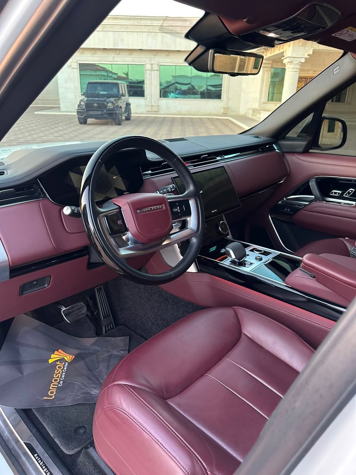 Range Rover interior: red leather, wood, touchscreen — Dubai, UAE