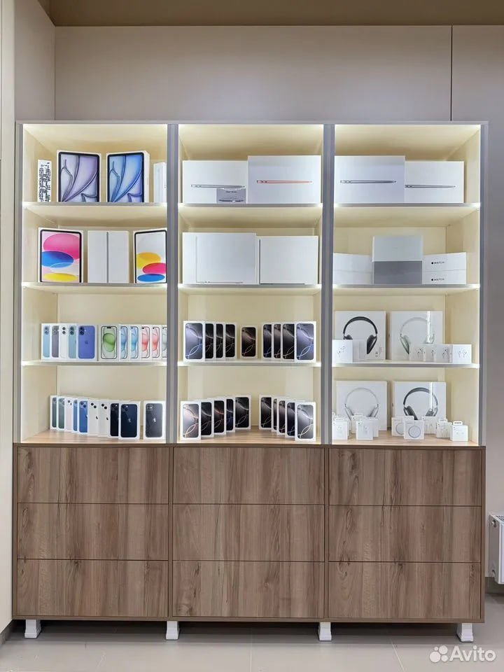 Modern and minimalist display case in a store. The display case is made of light-colored wood and has six shelves. The