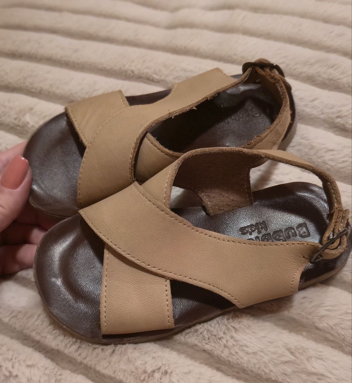 Pair of women's sandals. The sandals are made of leather and have a flat sole. They have a strap across the top of the foot