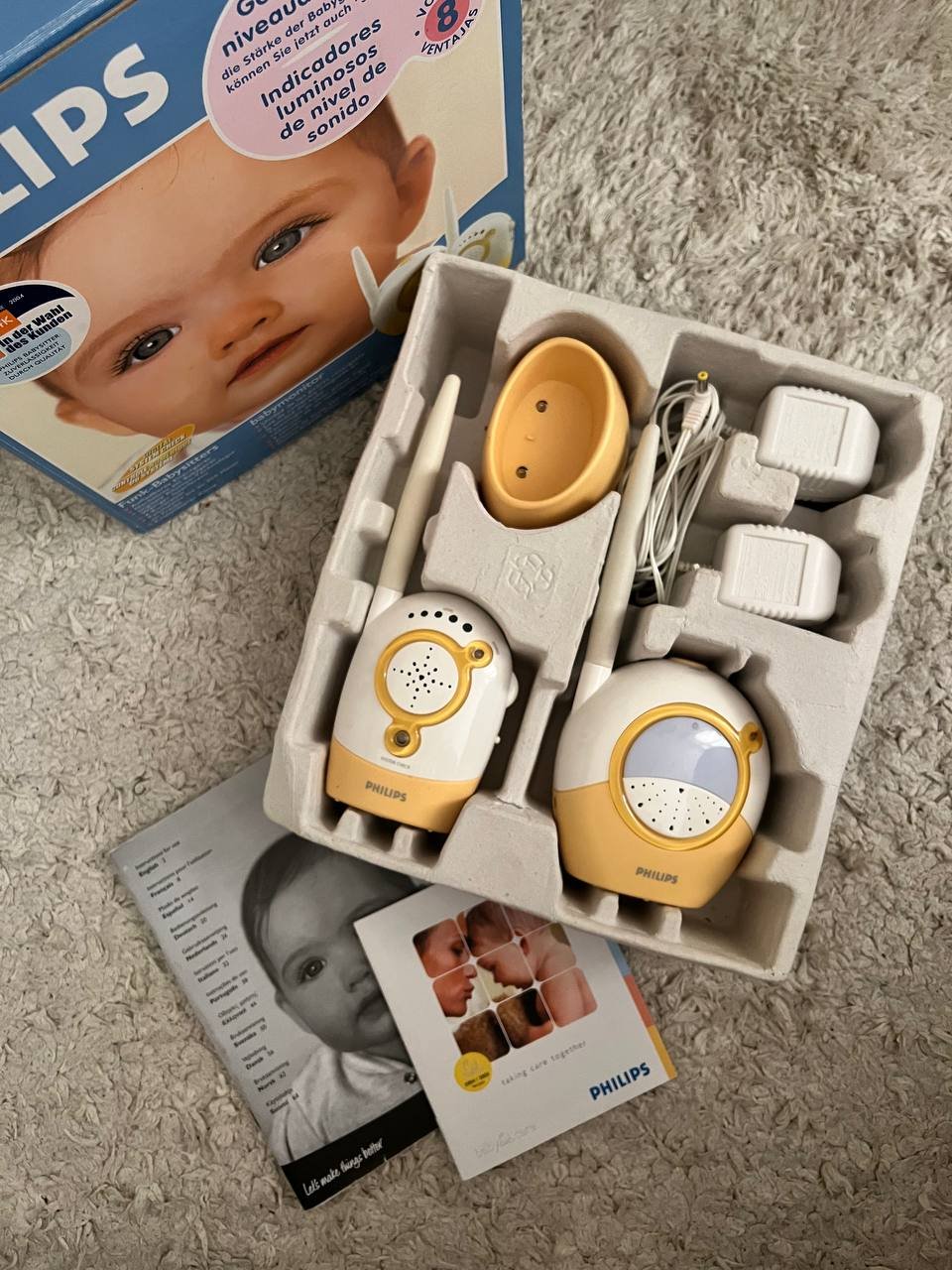 Philips baby monitor in its packaging. The packaging is a cardboard box with a picture of a baby's face on the top left