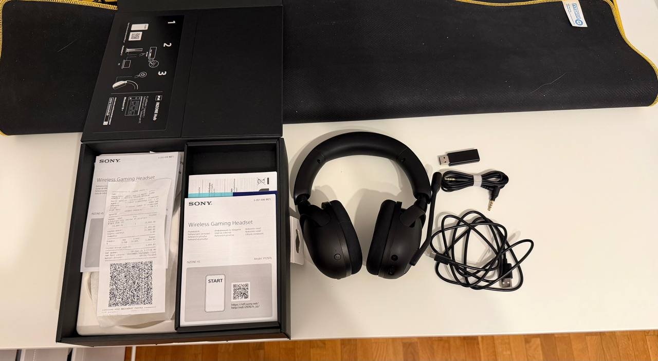 Black Sony wireless gaming headset in its packaging box. The box is open, revealing the headphones inside. The headphones